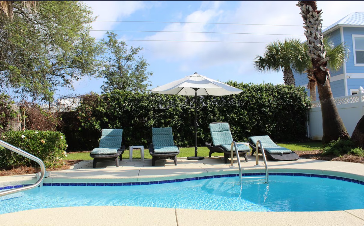 Private pool and lush backyard with lounge seating