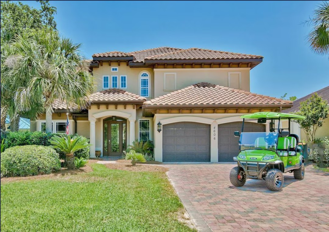 Luxury home exterior with lakefront views and golf cart